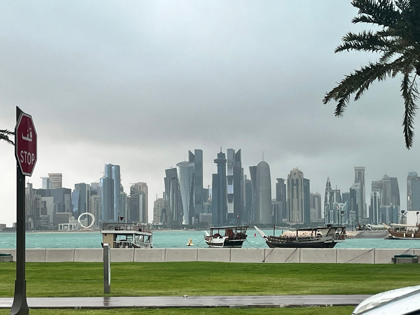 Doha Corniche skyline with traditional dhows and West Bay towers